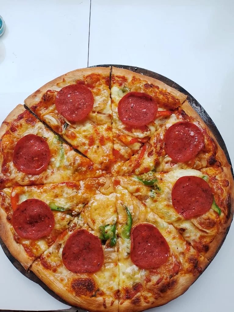 Wood-fired pepperoni pizza with peppers and onion at The Dining Room Candidasa